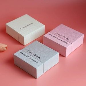 Three premium drawer-style jewelry gift boxes with textured surfaces in soft pastel colors