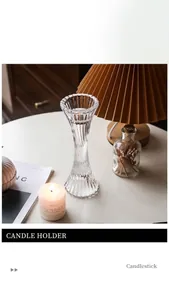 Detail view of transparent ribbed glass candle holder with a white pillar candle on a table