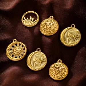 18K gold plated stainless steel sun and moon charms on dark brown silk fabric