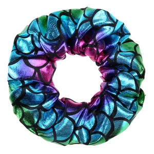 Close-up of a holographic mermaid scale pattern scrunchie with colorful metallic shine