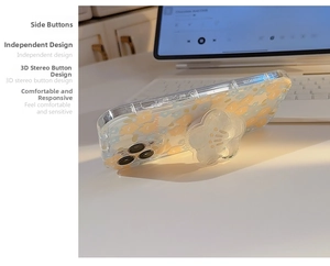Floral iPhone case with yellow blue flowers and flower-shaped grip stand on a white desk