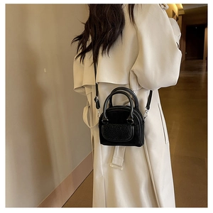 Black plush shell bag featuring stylish fuzzy pocket detail for autumn winter season