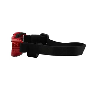 Detail of red heart-shaped pet goggles with black elastic strap and embossed side logo