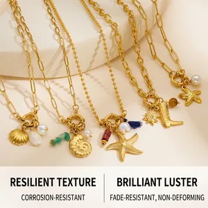 Detail of gold starfish and seashell pendants with pearls on colorful ocean necklaces