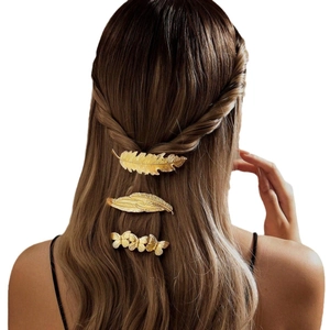 Vintage gold metal feather and leaf hair clip set styled on hair for women