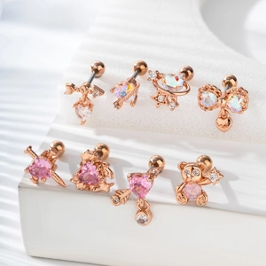 Rose gold heart and bear ear studs with pink cubic zirconia on a white display