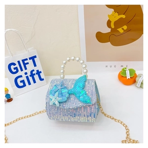 Detail of light blue sequin mermaid handbag with pearl handle and star decor