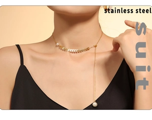 Detail of elegant gold wheat-shaped pendant necklace with white pearls on a model