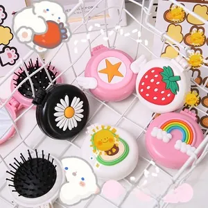 Detail of portable mini hairbrush with mirror and cute cartoon embossed patterns