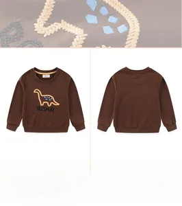Close-up of kids dinosaur embroidery and roar lettering on brown cotton sweatshirt
