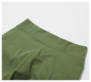 Detailed close-up of olive green yoga pants showing premium double-stitched waistband