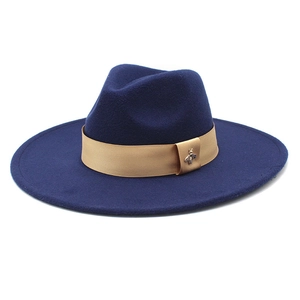 Detail of wool fedora hat with khaki ribbon and exquisite gold bee metal accessory