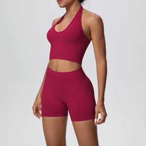 Detail of burgundy ribbed yoga set featuring a halter sports bra and high-waisted gym shorts