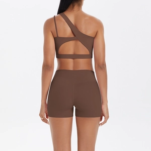 Brown one-shoulder yoga set with asymmetrical cutout back and high-waist sports shorts