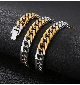 Detail of two-tone gold and silver Cuban link bracelets with secure box clasp closures