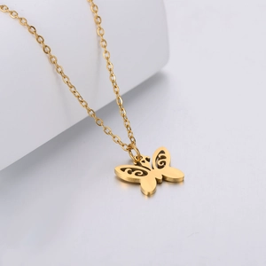 Gold hollow butterfly pendant necklace in titanium steel on a minimalist geometric background
