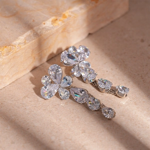 Detail of silver drop earrings with clear waterdrop cubic zirconia on stone base