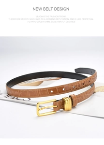 Macro detail of brown crocodile pattern leather belt with a polished gold pin buckle