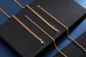 Detailed view of polished gold curb chain links with secure lobster clasp for men