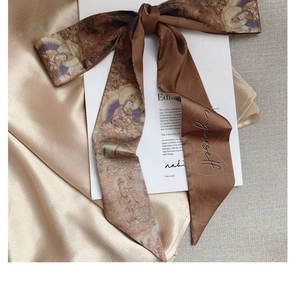 Detail of silk twilly scarf with vintage Buddha print and 'be yourself' embroidery