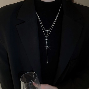 Detail of double-layered stainless steel star necklace with rhinestones on model