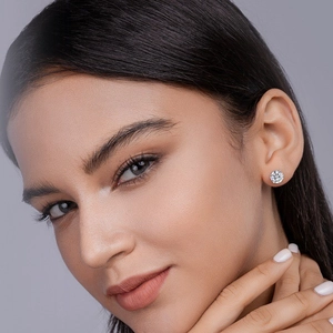 Elegant S925 silver moissanite stud earrings with classic six-prong setting on model