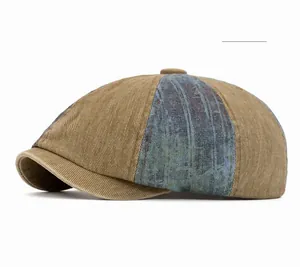 Detail of color-block patchwork denim beret showing textured corduroy and khaki blue tones