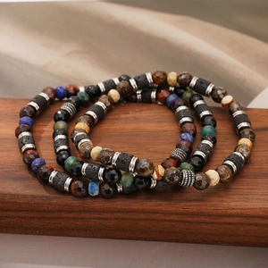 Natural volcanic rock and lapis lazuli beaded bracelets set on dark walnut wood stand
