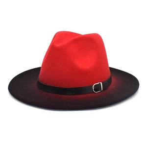 Detail of red and black gradient wool fedora hat featuring a leather belt and metal buckle