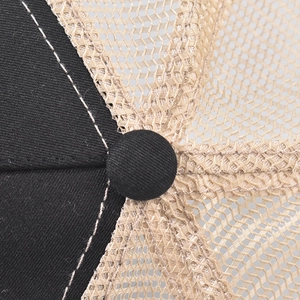 Close-up of baseball cap top with cotton fabric stitching and mesh ventilation detail