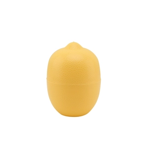 Close-up of yellow lemon-shaped plastic storage container with realistic fruit skin texture