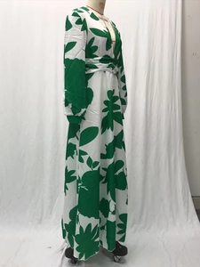 Detail of green leaf print maxi dress showing V-neckline and lantern sleeve texture