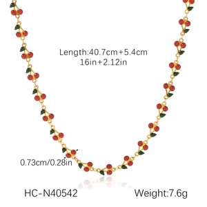 Detail view of gold cherry necklace showing length dimensions and red fruit pendant