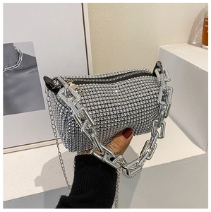 Detailed view of silver rhinestone handbag with chunky metal chain and zipper closure
