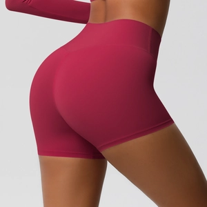 Detail view of high-waisted fitness shorts with lifting effect in dark rose red color