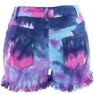 Detail view of tie-dye denim shorts featuring back pockets and distressed frayed hemline