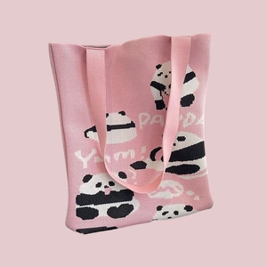 Detailed knit texture of pink panda tote bag featuring white Yum and PANDA text patterns