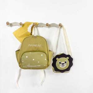 Detail of green lion backpack set with detachable mini shoulder bag and star patterns