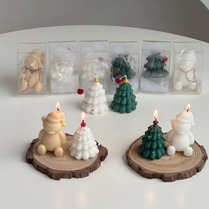 Mini Christmas tree and bear scented candles displayed in transparent PVC gift packaging