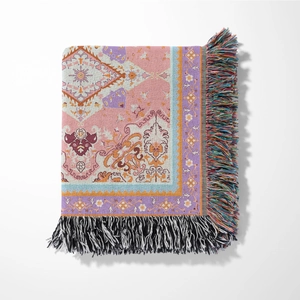 Detail of bohemian woven blanket featuring colorful geometric patterns and decorative tassels