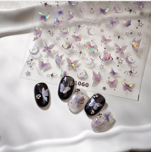 Macro detail of iridescent butterfly and moon nail stickers with holographic silver finish