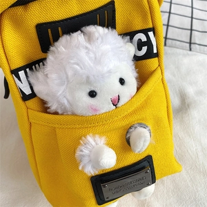 Close-up of bright yellow canvas crossbody bag featuring a cute 3D plush sheep detail
