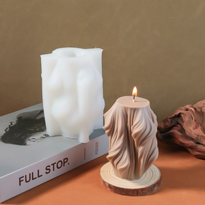 Macro detail of silicone mold alongside finished wavy candle with elegant fluid texture