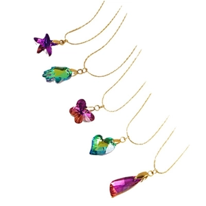 Gold necklaces featuring assorted colorful crystal pendants in star heart and butterfly shapes