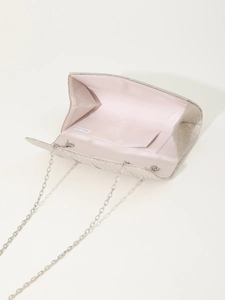 Detail view of champagne glitter evening bag showing interior pocket and silver chain strap