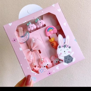 Detail der rosa Geschenkbox mit niedlichen Zeichentrick-Haarspangen mit Schleifen