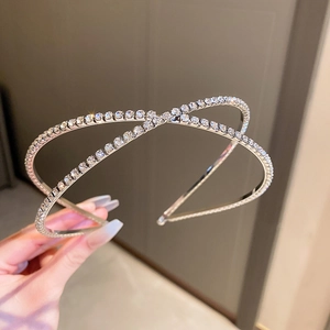 Princess style silver criss-cross headband with sparkling rhinestones for parties