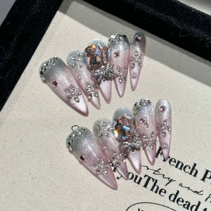Handmade stiletto press-on nails with pink glitter gradient, jewels and butterfly charms