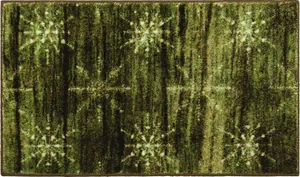 Detailed close-up of dark green Christmas rug with white snowflake patterns and non-slip texture