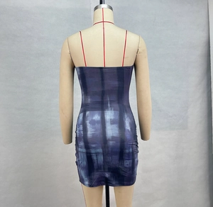 Detail view of the back of a purple plaid bodycon mini dress on a mannequin